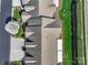 Overhead aerial view of townhome roofs surrounded by lush lawns and mature landscaping at 489 26Th Ne Ave # C, Hickory, NC 28601