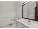 Well-lit bathroom with white fixtures, grab bars, and a large mirror over the vanity at 489 26Th Ne Ave # C, Hickory, NC 28601