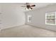 Spacious bedroom featuring neutral carpet, two large windows, and a ceiling fan at 489 26Th Ne Ave # C, Hickory, NC 28601