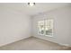 Bright bedroom with neutral carpet, white walls and natural light from a window at 489 26Th Ne Ave # C, Hickory, NC 28601