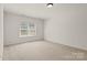 Bright bedroom with large window offering natural light and neutral carpet at 489 26Th Ne Ave # C, Hickory, NC 28601