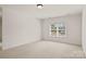 Bright, carpeted bedroom featuring a large window that floods the room with natural light at 489 26Th Ne Ave # C, Hickory, NC 28601