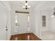 Bright foyer with hardwood floors and a modern chandelier, creating a welcoming entrance at 489 26Th Ne Ave # C, Hickory, NC 28601
