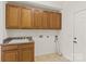 Functional laundry room with cabinets, sink, and tile flooring for easy cleaning at 489 26Th Ne Ave # C, Hickory, NC 28601