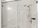 Enclosed shower stall with glass door and accessible grab bar and shelving at 489 26Th Ne Ave # C, Hickory, NC 28601
