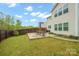 Beautiful backyard with patio, dark wood fence and lush green grass, perfect for outdoor entertaining at 5109 Arbordale Way, Mount Holly, NC 28120