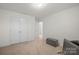 Bedroom featuring neutral carpet, double closets and a view to an adjoining room at 5109 Arbordale Way, Mount Holly, NC 28120