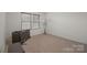 Cozy bedroom with plush carpeting, a window with blinds, and a floor lamp at 5109 Arbordale Way, Mount Holly, NC 28120