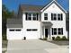 Charming two-story home features a two-car garage, well-maintained lawn, and classic architectural details at 5109 Arbordale Way, Mount Holly, NC 28120