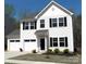 Charming two-story home features a two-car garage, well-maintained lawn, and classic architectural details at 5109 Arbordale Way, Mount Holly, NC 28120