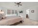 Bright and airy main bedroom with tray ceiling, large windows and ensuite bathroom at 5109 Arbordale Way, Mount Holly, NC 28120