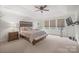 Spacious main bedroom with neutral carpet, tray ceiling, lots of windows, and a ceiling fan at 5109 Arbordale Way, Mount Holly, NC 28120