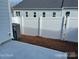 Enclosed backyard with a white privacy fence, patio, and modern AC unit for added comfort at 534 Dorman St, Belmont, NC 28012