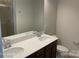 Bathroom with double sink vanity, white countertops, and a framed mirror at 534 Dorman St, Belmont, NC 28012