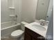 Full bathroom with tiled shower and bath, large mirror, and a white quartz countertop at 534 Dorman St, Belmont, NC 28012