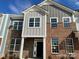 Exterior of brick townhome with gray siding and a covered front porch at 534 Dorman St, Belmont, NC 28012