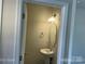 Cozy powder room features pedestal sink, oval mirror, and sconce lighting at 534 Dorman St, Belmont, NC 28012