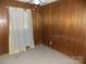 Bedroom with carpeted floors and wood paneling at 543 Queens Rd, Gastonia, NC 28052