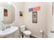 Small bathroom features a pedestal sink, toilet, and decorated walls at 6010 Hawk View Rd, Waxhaw, NC 28173