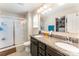 Bright bathroom featuring a double vanity with granite countertop and glass-enclosed shower at 6010 Hawk View Rd, Waxhaw, NC 28173
