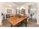Dining area featuring a rustic table, modern lighting, and an open view into the kitchen at 6010 Hawk View Rd, Waxhaw, NC 28173