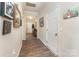 Hallway with wood floors and neutral paint, providing access to other rooms at 6010 Hawk View Rd, Waxhaw, NC 28173