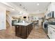 Open concept kitchen with island, granite countertops, stainless appliances, and hardwood floors at 6010 Hawk View Rd, Waxhaw, NC 28173