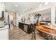 Open-concept kitchen with dark cabinetry, granite countertops, stainless steel appliances, and laminate floors at 6010 Hawk View Rd, Waxhaw, NC 28173