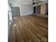 This living room features a ceiling fan, barn door, and brick wall at 6372 Morehead St, Harrisburg, NC 28075