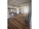 Spacious living room featuring hardwood floors and a cozy brick fireplace at 6372 Morehead St, Harrisburg, NC 28075