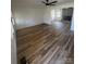 Spacious living room boasts gleaming hardwood floors, abundant natural light, and a cozy fireplace at 6372 Morehead St, Harrisburg, NC 28075