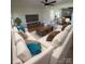 Bright living room featuring a large sectional sofa and stylish decor with an adjacent dining area at 6372 Morehead St, Harrisburg, NC 28075
