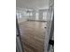 Bright living room with multiple windows and wood flooring, perfect for entertaining at 6372 Morehead St, Harrisburg, NC 28075
