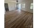 This living room features a ceiling fan, front door, and a couple of windows at 6372 Morehead St, Harrisburg, NC 28075