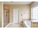 Bright bathroom featuring a large tub, glass shower and neutral toned tile at 641 Weyburn Nw Dr, Concord, NC 28027