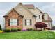 Charming two-story home with a well-manicured lawn and stone and brick exterior, exuding curb appeal at 641 Weyburn Nw Dr, Concord, NC 28027