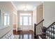 Elegant foyer featuring hardwood floors, a staircase with dark wood railing, and natural light at 641 Weyburn Nw Dr, Concord, NC 28027