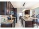 Well-equipped kitchen featuring dark wood cabinetry, granite countertops, and stainless steel appliances at 641 Weyburn Nw Dr, Concord, NC 28027