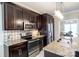 Modern kitchen showcasing stainless steel appliances, granite counters and dark wood cabinets at 641 Weyburn Nw Dr, Concord, NC 28027