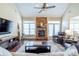 Inviting living room with stone fireplace, hardwood floors, and plenty of natural light at 641 Weyburn Nw Dr, Concord, NC 28027