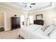 Spacious main bedroom featuring a tray ceiling, ceiling fan, and stylish decor at 641 Weyburn Nw Dr, Concord, NC 28027
