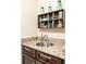Elegant granite countertop vanity with dark wood cabinets, providing a stylish and functional space at 641 Weyburn Nw Dr, Concord, NC 28027