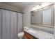 Bathroom with updated vanity, mirror, and shower with white curtain at 676 Forest Nw St, Concord, NC 28025