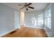 Open bedroom featuring hardwood floors, a window, and a ceiling fan at 676 Forest Nw St, Concord, NC 28025