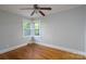 A light filled bedroom featuring well-maintained hardwood floors at 676 Forest Nw St, Concord, NC 28025