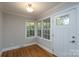 Bright entryway with hardwood floors and traditional paned windows and door at 676 Forest Nw St, Concord, NC 28025