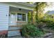 Charming front porch featuring a glass paneled door and stone accents at 676 Forest Nw St, Concord, NC 28025