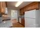 Bright kitchen with hardwood floors, granite counters, and a full suite of white appliances at 676 Forest Nw St, Concord, NC 28025