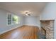 Spacious living room with hardwood floors, fireplace, and large window at 676 Forest Nw St, Concord, NC 28025