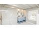 Bright bathroom featuring marble style wall tile, double sinks, modern fixtures and a window at 678 Wagner St, Troutman, NC 28166